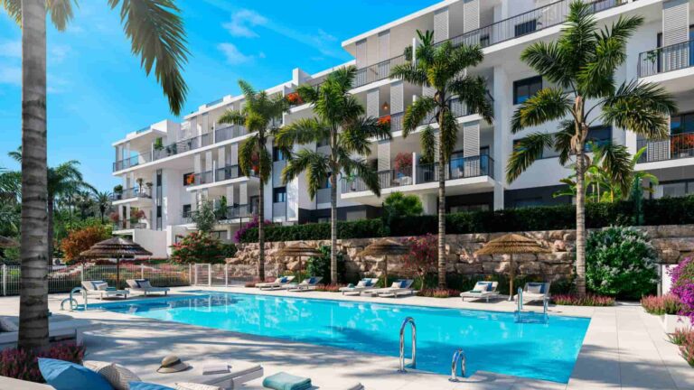 Modern residential complex with a communal swimming pool, sun loungers, and lush palm trees, showcasing the tailored investment strategies possible in such desirable real estate developments.